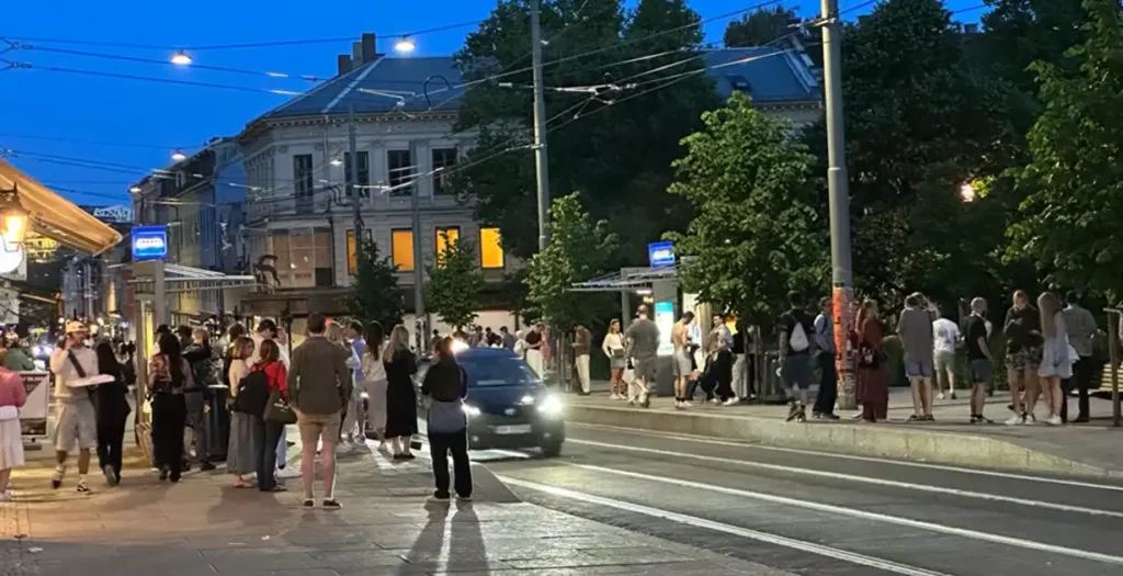 A late night in Oslo near Olaf Ryes Plass on Grünerløkka where people are waiting for the tram.